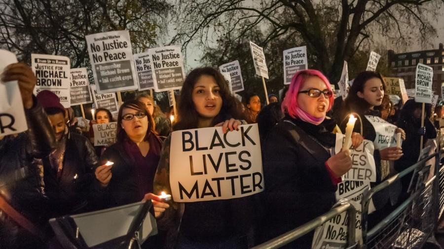 26 Nov 2014, London, England, UK --- London, United Kingdom. 26th November 2014 -- People hold candles, posters and placards at the candlelit vigil for Michael Brown, calling for justice and stressing that Black Lives Matter. -- Over a thousand people, angry at the decision not to charge Darren Wilson with murder, attended a candlelit vigil at the US Embassy calling for justice and an end to the racism that allows police in the US and UK to shoot black people. --- Image by © Peter Marshall/Demotix/Corbis