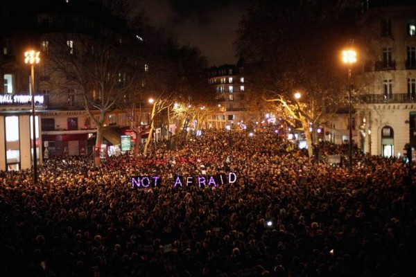 People gather to pay respect for the victims of a terror attack against a satirical newspaper, in Paris, in Paris, Wednesday, Jan. 7, 2015. Masked gunmen shouting Allahu akbar! stormed the Paris offices of a satirical newspaper Wednesday, killing 12 people, including the papers editor, before escaping in a getaway car. It was Frances deadliest terror attack in living memory. (AP Photo/Thibault Camus)