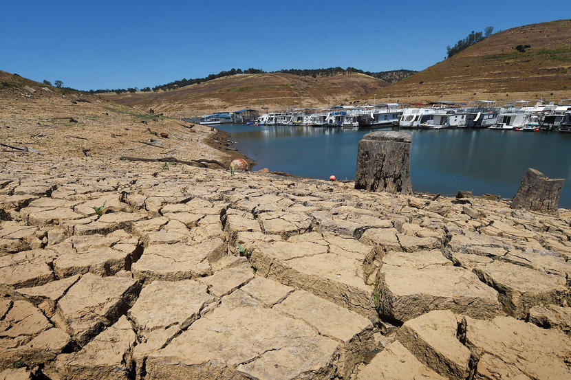 Dried mud and the remnants of a marina is seen at the New Melones Lake reservoir which is now at less than 20 percent capacity as a severe drought continues to affect California on May 24, 2015.  California has recently announced sweeping statewide water restrictions for the first time in history in order to combat the regions devastating drought, the worst since records began.          AFP PHOTO/ MARK RALSTON        (Photo credit should read MARK RALSTON/AFP/Getty Images)