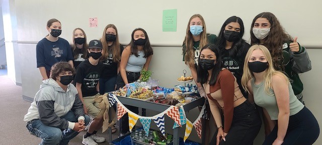 ASB students going around with their treat cart surprising teachers.